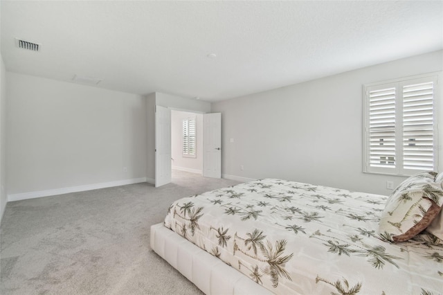 carpeted bedroom featuring multiple windows