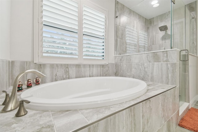 bathroom featuring plenty of natural light and plus walk in shower