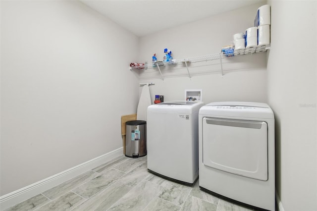 clothes washing area featuring washer and dryer