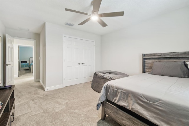 carpeted bedroom with a closet and ceiling fan