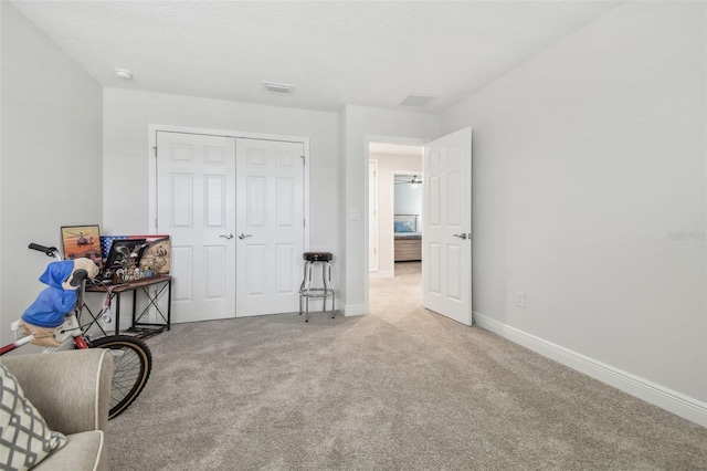 bedroom featuring light carpet and a closet