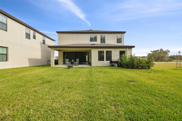 rear view of property featuring a yard and a patio