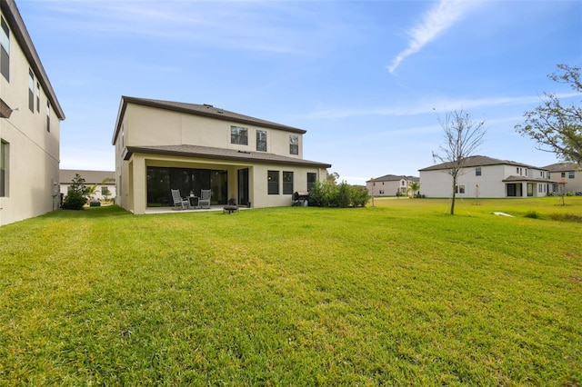 rear view of house featuring a lawn