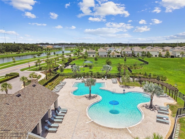 view of pool featuring a water view and a patio