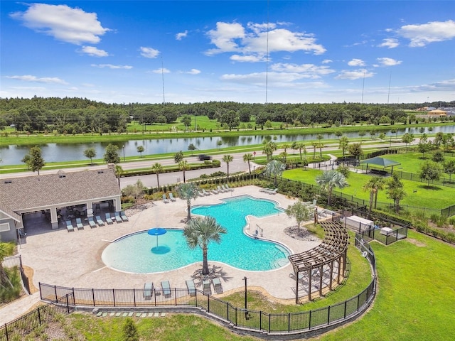 view of pool with a water view, a yard, and a patio area