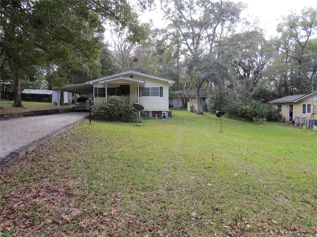 view of front facade with a front yard and a carport