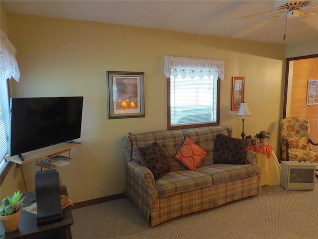 carpeted living room featuring ceiling fan