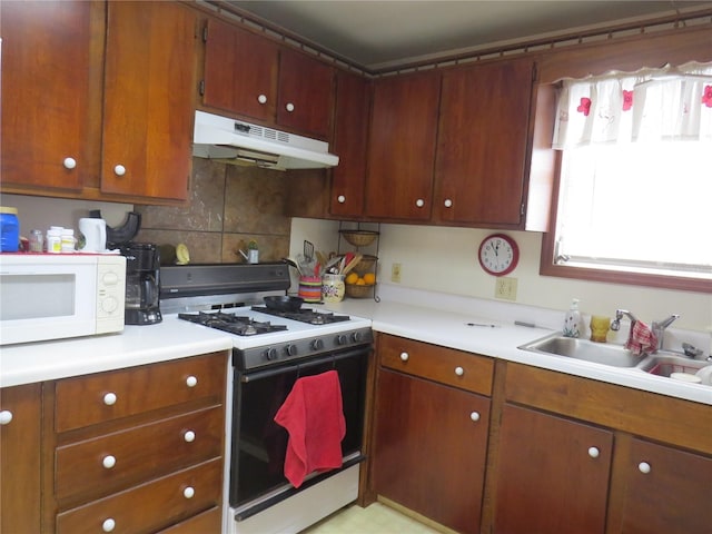 kitchen with sink, range with gas stovetop, and decorative backsplash