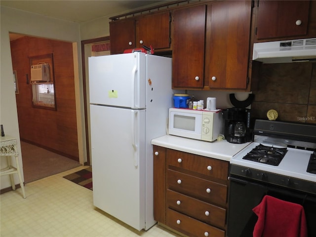 kitchen with a wall mounted AC and white appliances