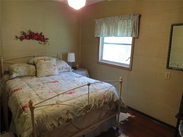 bedroom with wood-type flooring