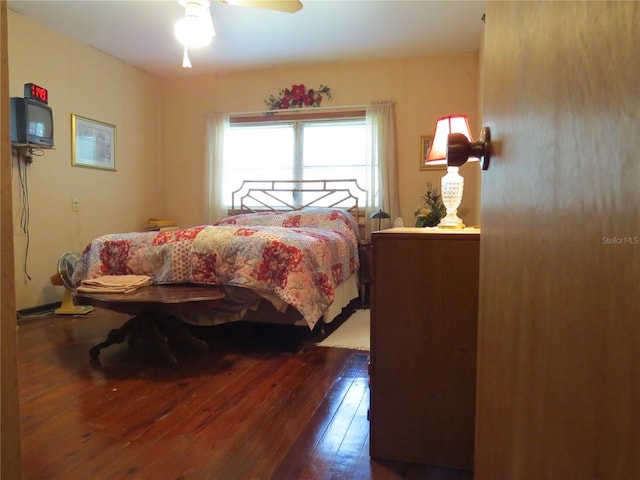 bedroom with ceiling fan and dark hardwood / wood-style flooring