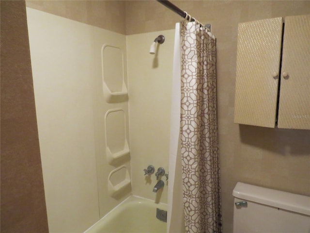 bathroom featuring toilet and shower / bathtub combination with curtain