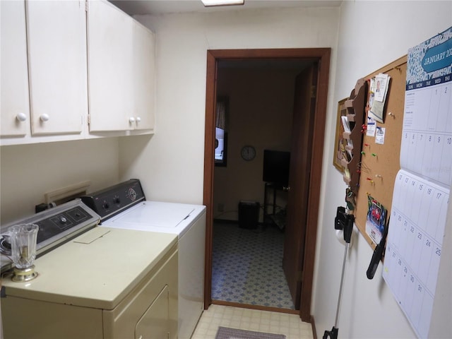 washroom featuring cabinets and separate washer and dryer