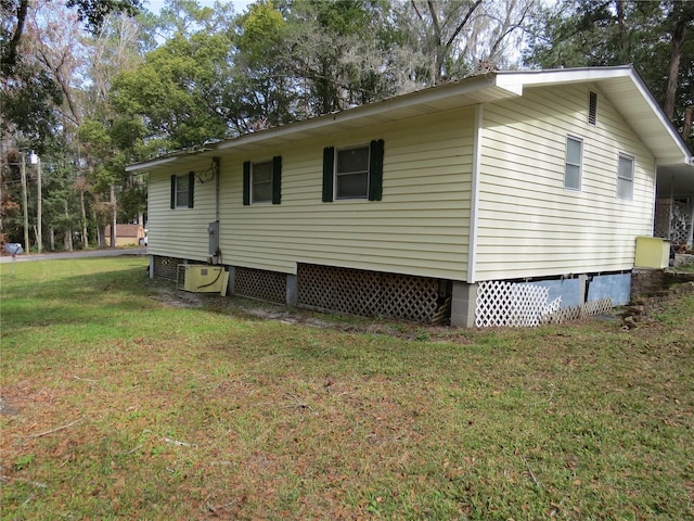 view of side of property with a lawn