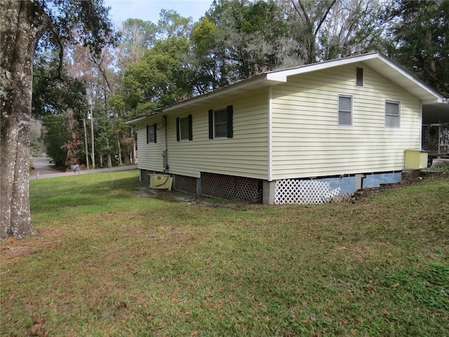 view of property exterior with ac unit and a yard