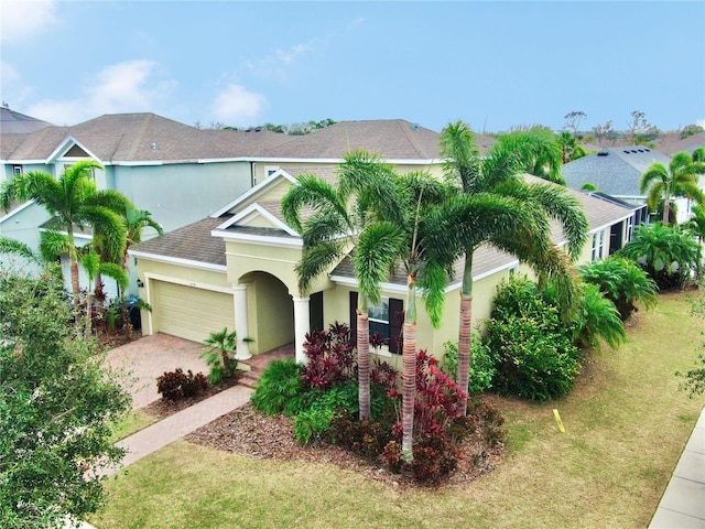 view of front of home featuring a front yard and a garage