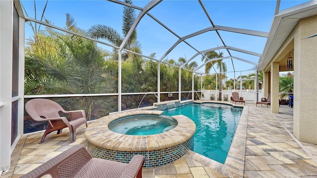 view of pool with a lanai, a patio area, and an in ground hot tub