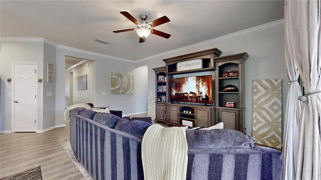 living room with ceiling fan, light hardwood / wood-style flooring, and ornamental molding