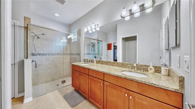 bathroom with vanity, tile patterned flooring, and an enclosed shower