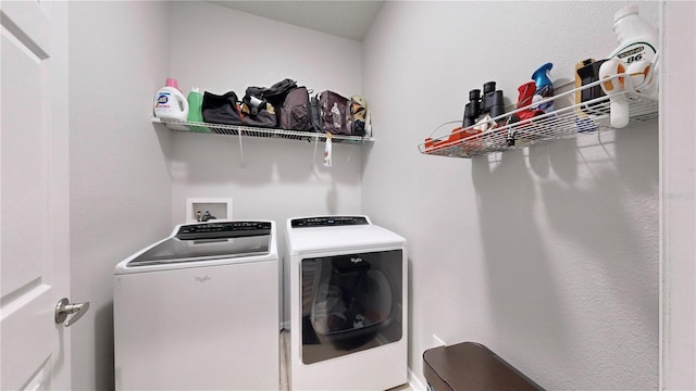 clothes washing area with washing machine and dryer