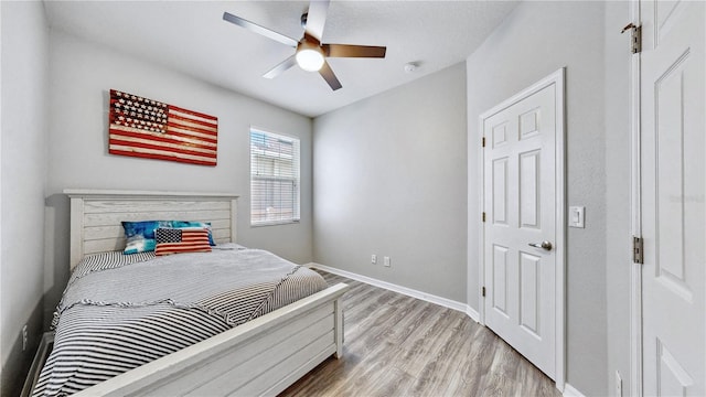 bedroom with ceiling fan and light wood-type flooring