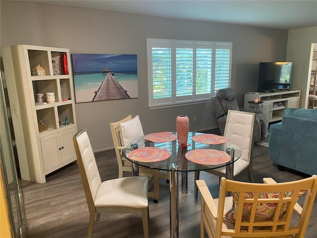 dining area with dark hardwood / wood-style flooring