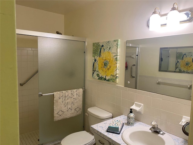 bathroom featuring a shower with shower door, tile walls, toilet, and vanity