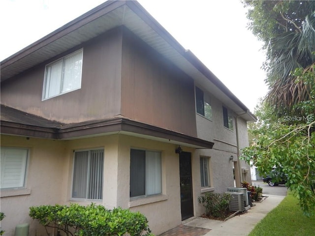 view of side of home featuring cooling unit