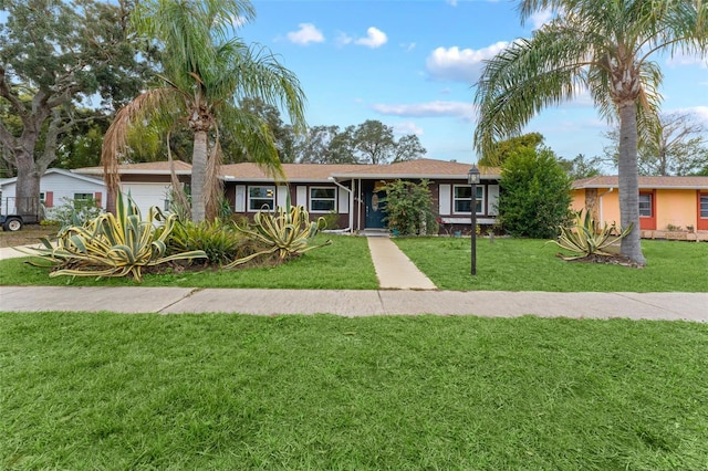 single story home featuring a front yard