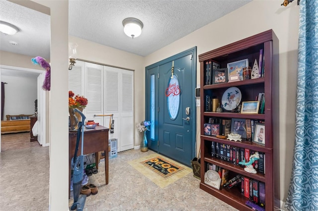 entrance foyer with a textured ceiling