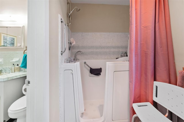 bathroom with toilet and a shower with shower curtain