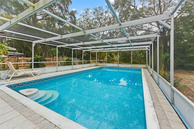 view of pool with glass enclosure