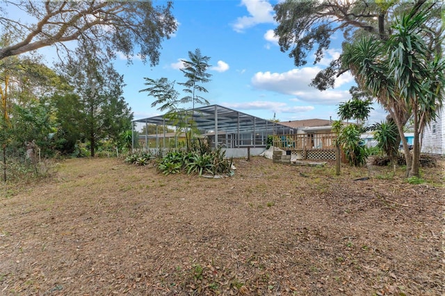 view of yard with glass enclosure