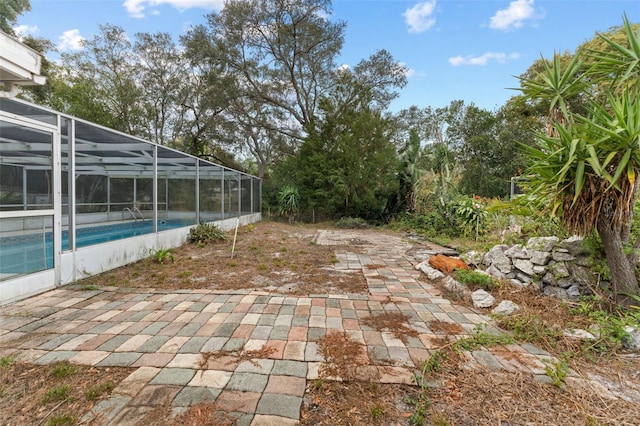 view of yard featuring glass enclosure