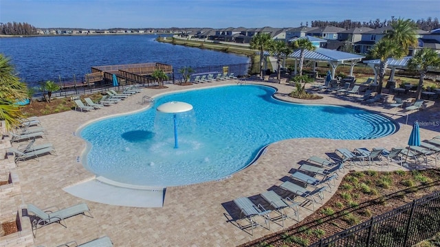 view of pool with a water view and a patio area