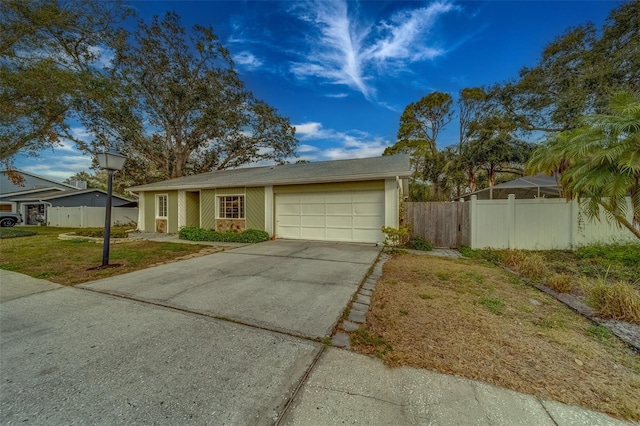 single story home featuring a front yard and a garage