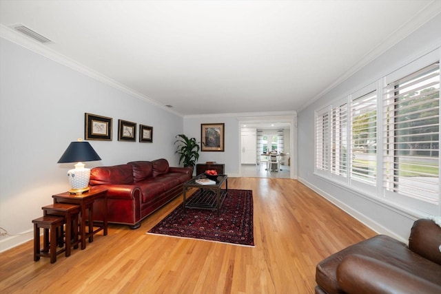 living room with crown molding and hardwood / wood-style flooring