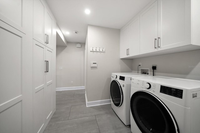 washroom featuring independent washer and dryer and cabinets