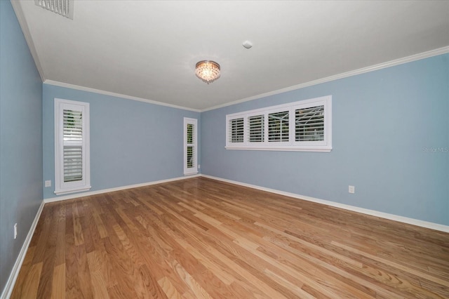 unfurnished room featuring light wood-type flooring and crown molding