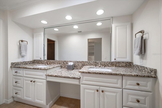 bathroom with ornamental molding and vanity