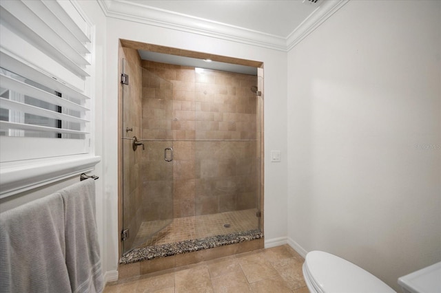 bathroom with toilet, ornamental molding, and an enclosed shower