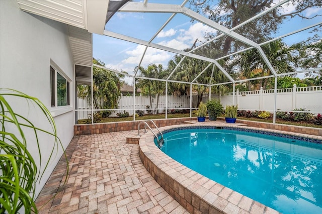 view of pool with a lanai and a patio area