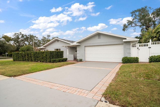 ranch-style home featuring a garage and a front lawn