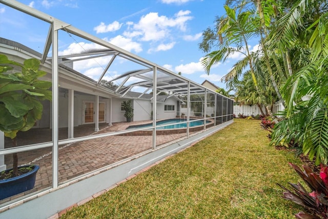 view of yard with a patio and glass enclosure