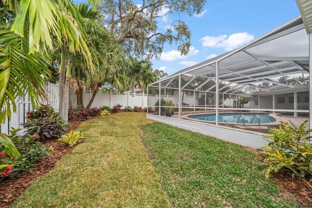 view of yard with a lanai and a fenced in pool