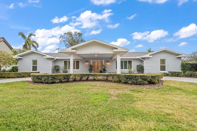 view of front of property featuring a front lawn and french doors