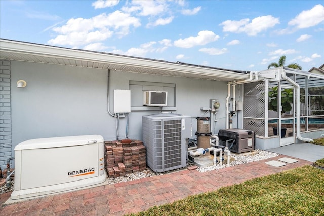 view of patio featuring a lanai and central air condition unit