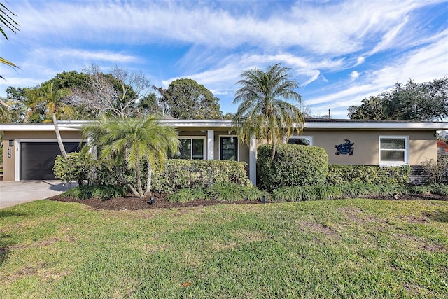 view of front of property with a garage and a front lawn