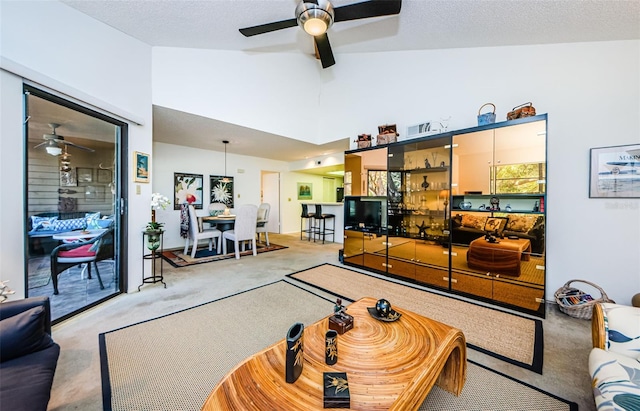 204 Lennox Rd W, W, Palm Harbor, FL 34683 - carpeted living room featuring ceiling fan, high vaulted ceiling, and a textured ceiling