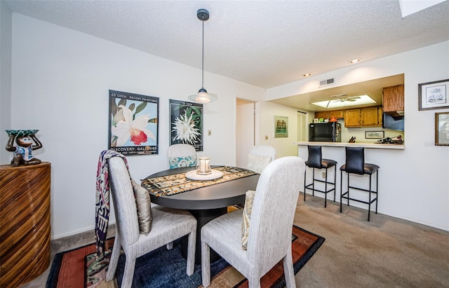 204 Lennox Rd W, W, Palm Harbor, FL 34683 - dining room featuring light carpet and a textured ceiling